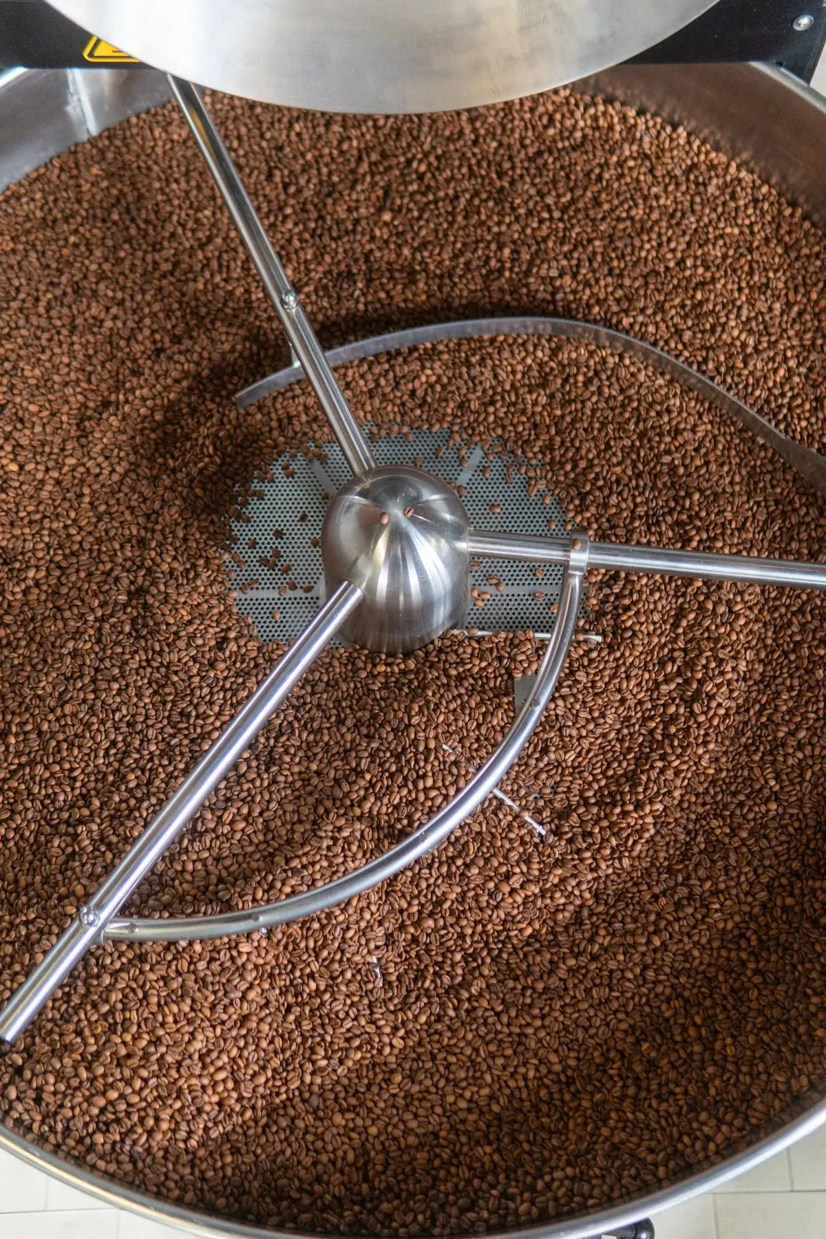 Coffee beans in the roasting drum at The Folks roastery